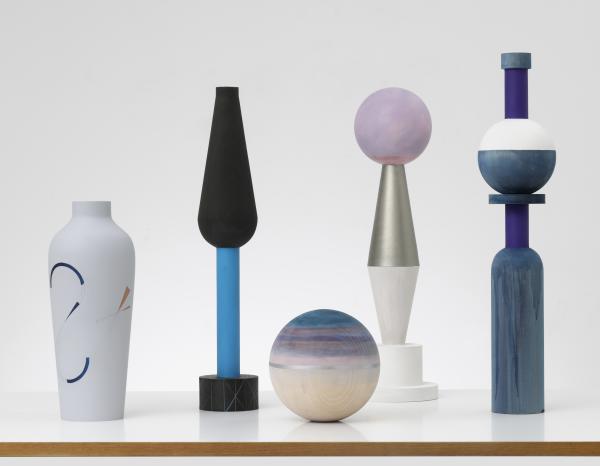 Several color geometric ceramic pieces of art by Claudia Wieser against a white backdrop